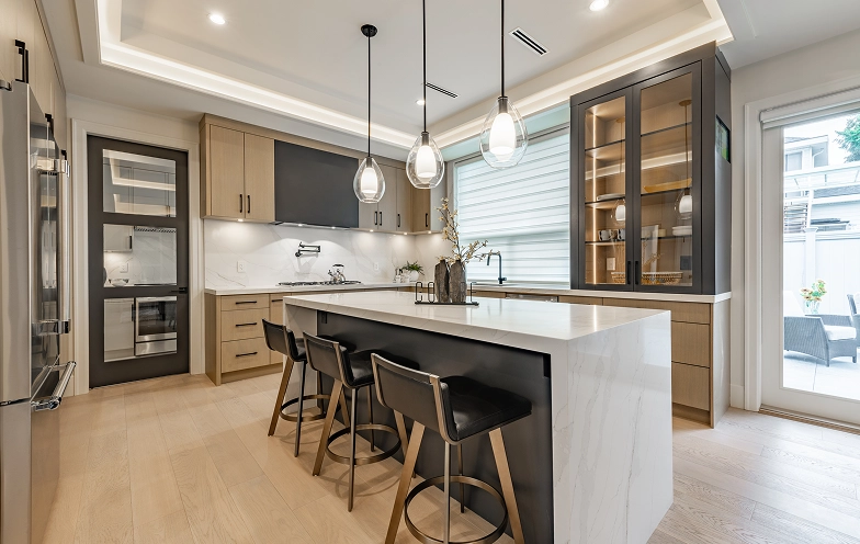 Modern kitchen with island and bar stools.