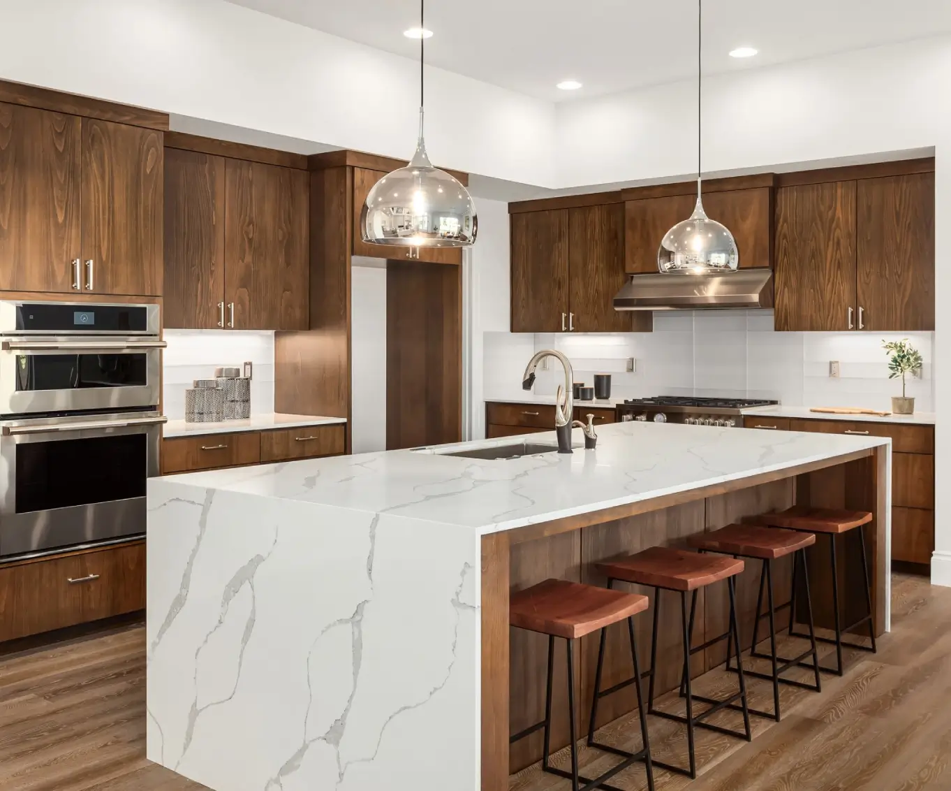 Modern kitchen with island and wooden cabinets.