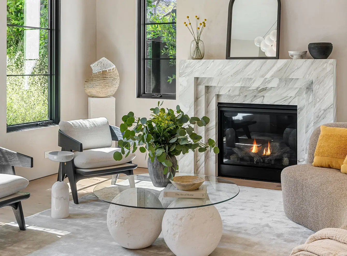 Modern living room with fireplace and plants.
