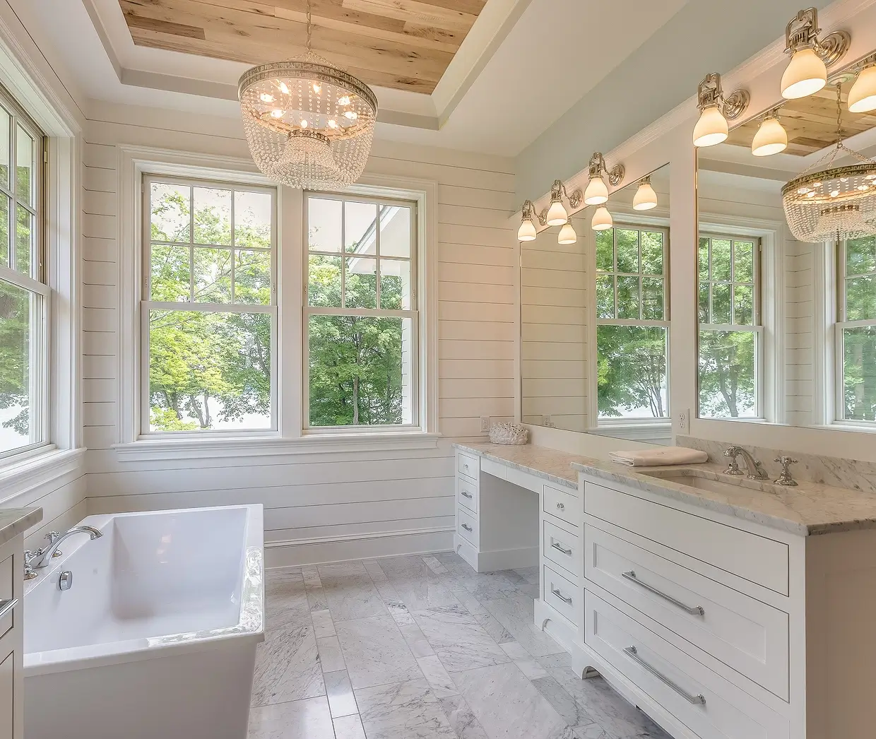 Luxurious bathroom with chandelier and bathtub.